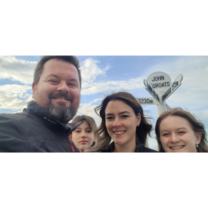 Dean, Erin, and their daughters at John O'Groats, Scotland