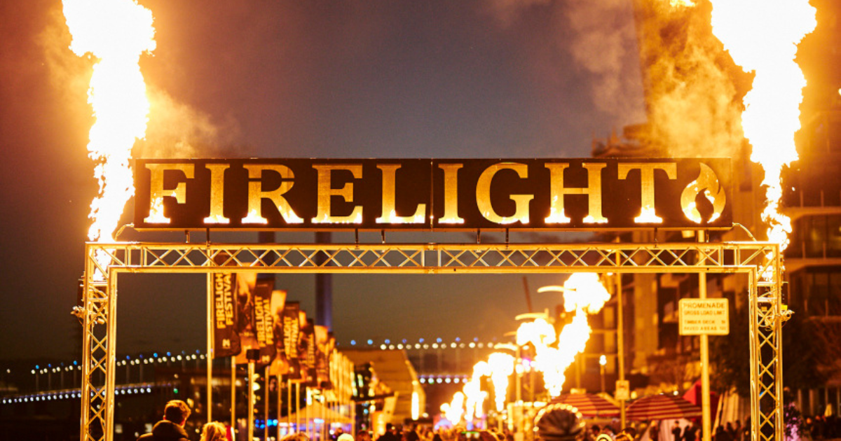 Flaming Firelight Festival sign with fireballs in the air at Docklands 2025