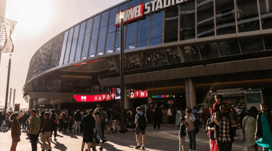 Crowds gathered outside Marvel Stadium in Docklands, Melbourne on a sunny event day.